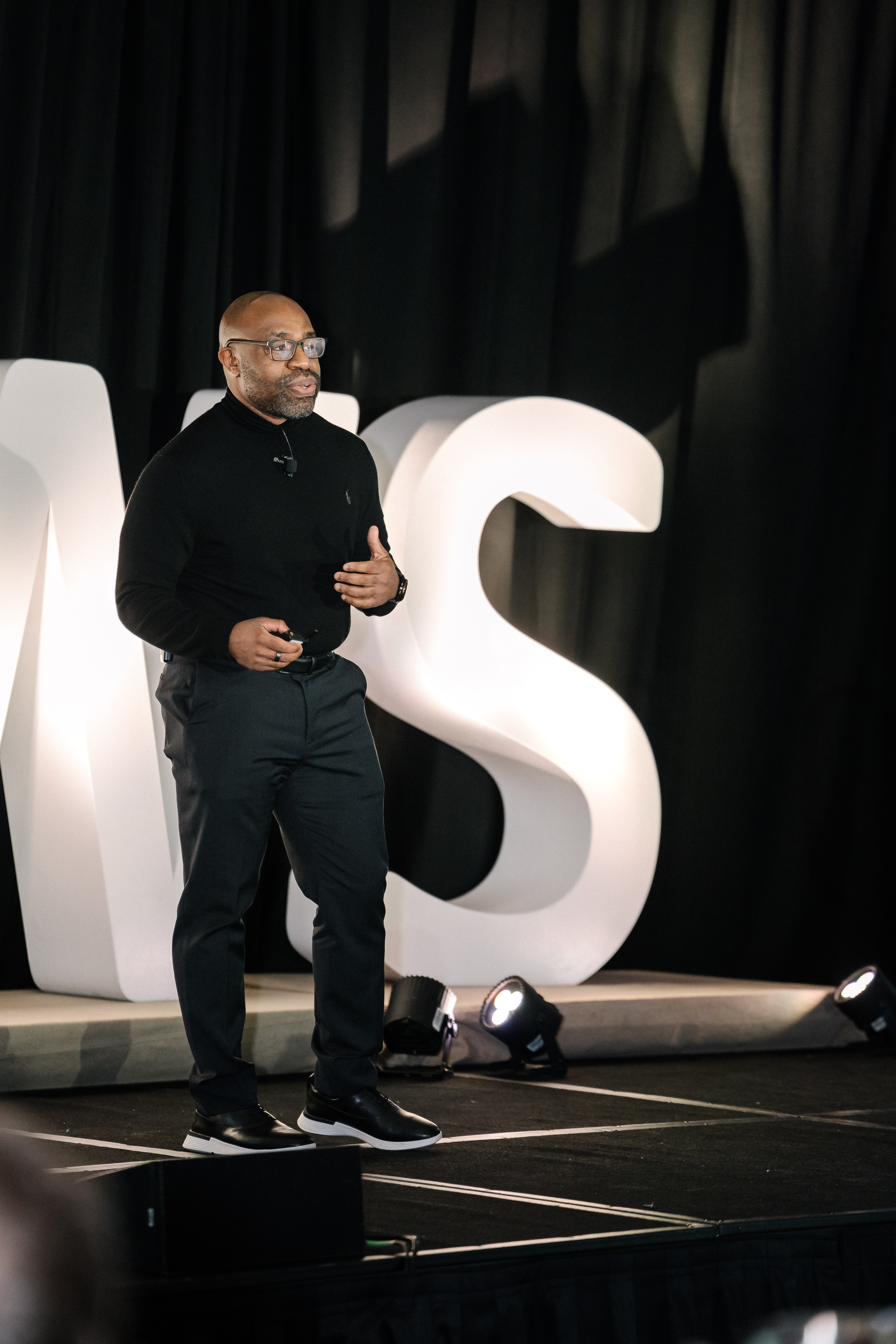 Olawale Oladehin speaking on stage